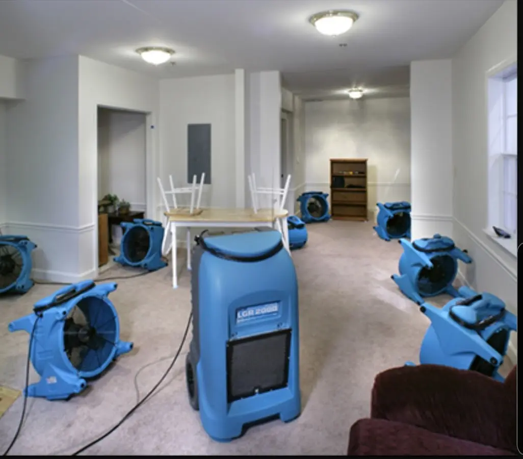 Air movers and dehumidifier setup for Water Damage Restoration in Badger